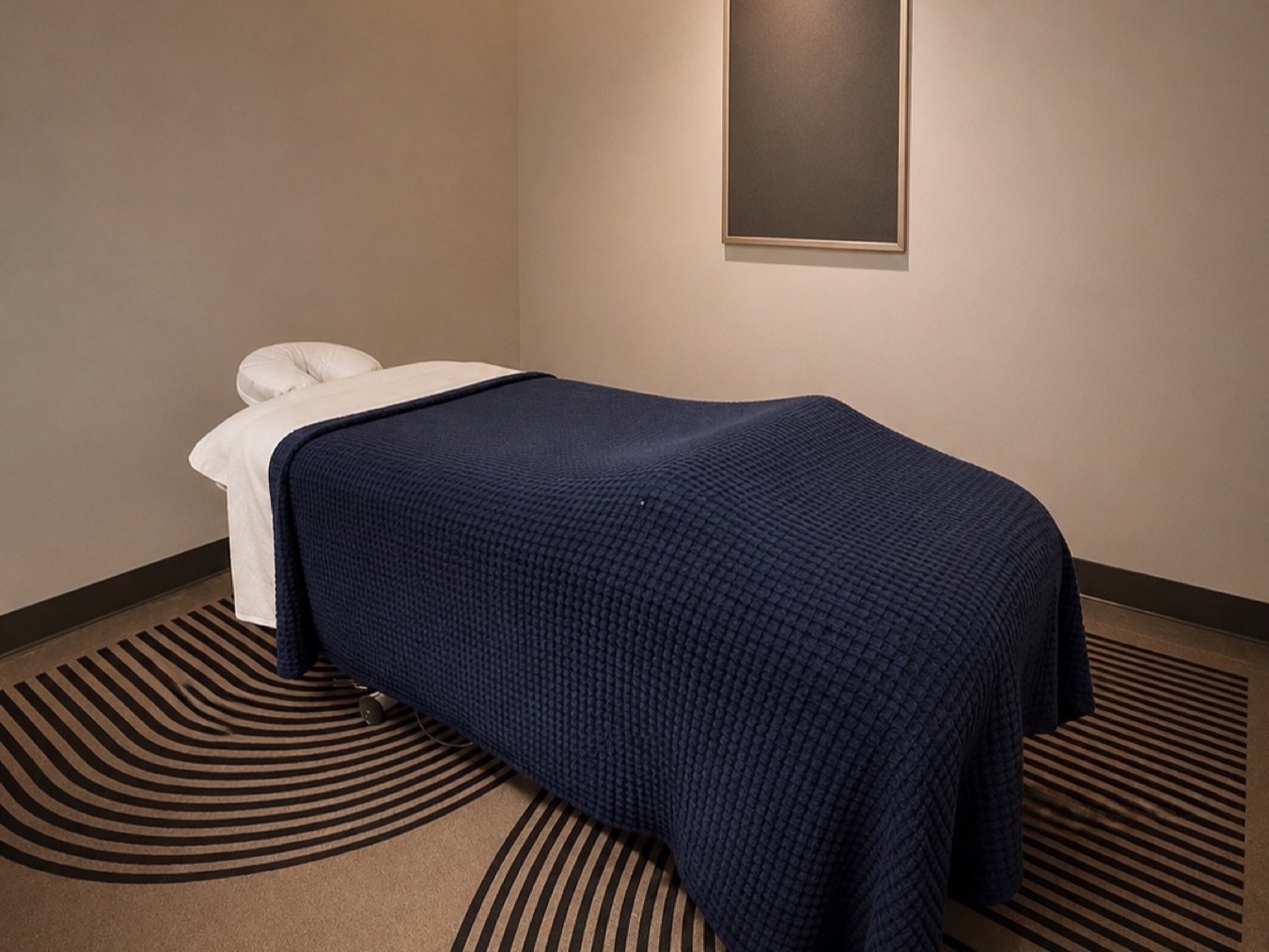 Massage room at Sauna House with a draped table and warm lighting