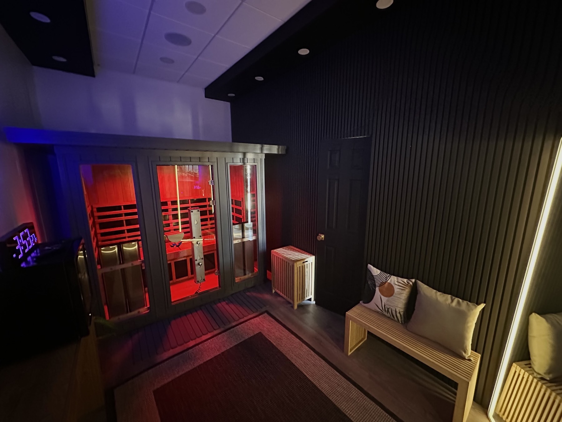 Infrared sauna cabin glowing red inside a private Sauna House suite